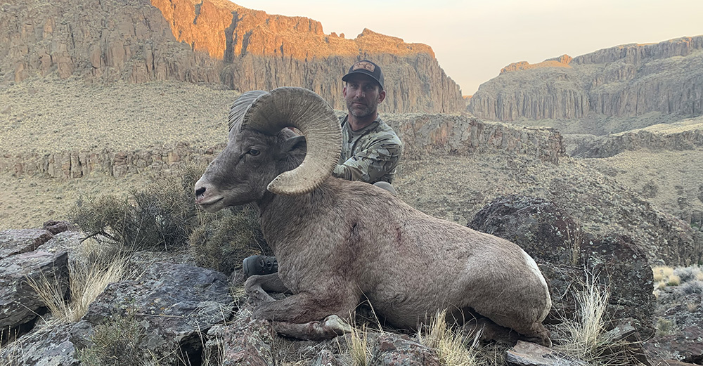 KC RAMSEY ADMIRES THE IMPRESSIVE HORNS OF THE RAM HE HARVESTED IN IDAHO DURING THE 2021 SEASON. KC RAMSEY ADMIRES THE IMPRESSIVE HORNS OF THE RAM HE HARVESTED IN IDAHO DURING THE 2021 SEASON.