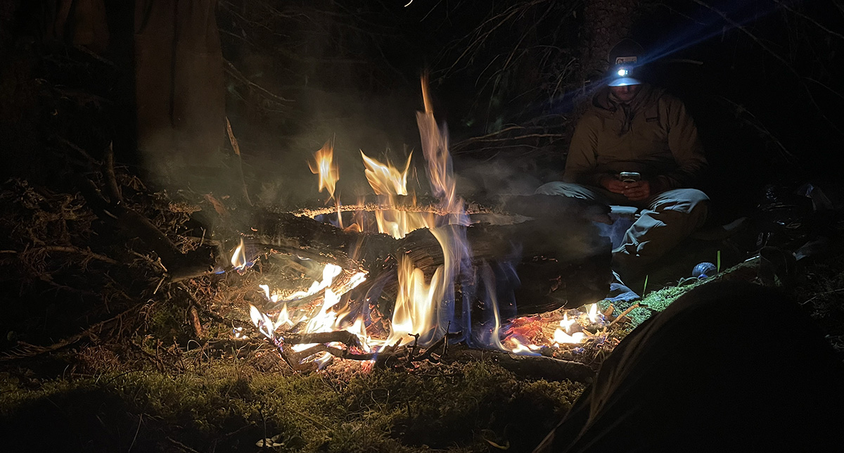 Hunters sitting around a campfire Hunters sitting around a campfire
