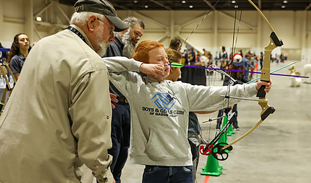 Youth learning archery at the 2024 YWCE event Youth learning archery at the 2024 YWCE event