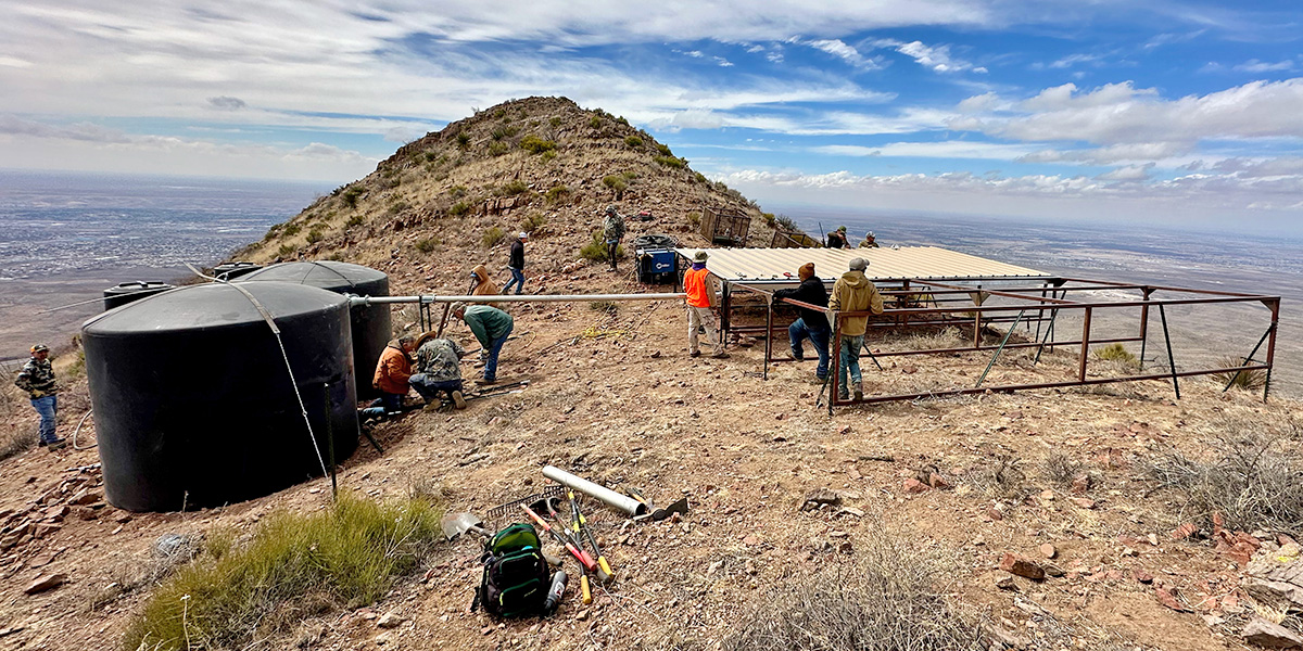 Volunteers installing water guzzler systems high up on in the Franklin Mountain State Park Volunteers installing water guzzler systems high up on in the Franklin Mountain State Park