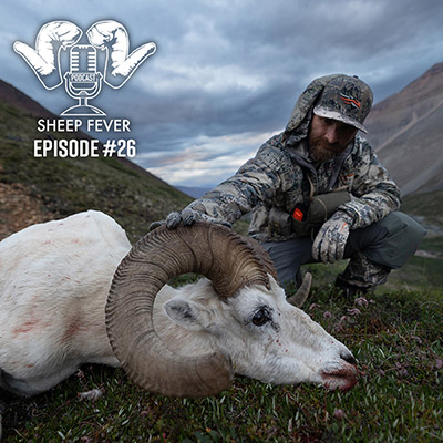 Jason Matzinger on a mountainside with a Dall's ram.