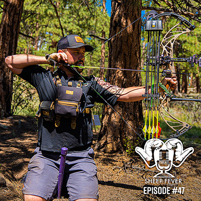 man shooting a bow in the woods
