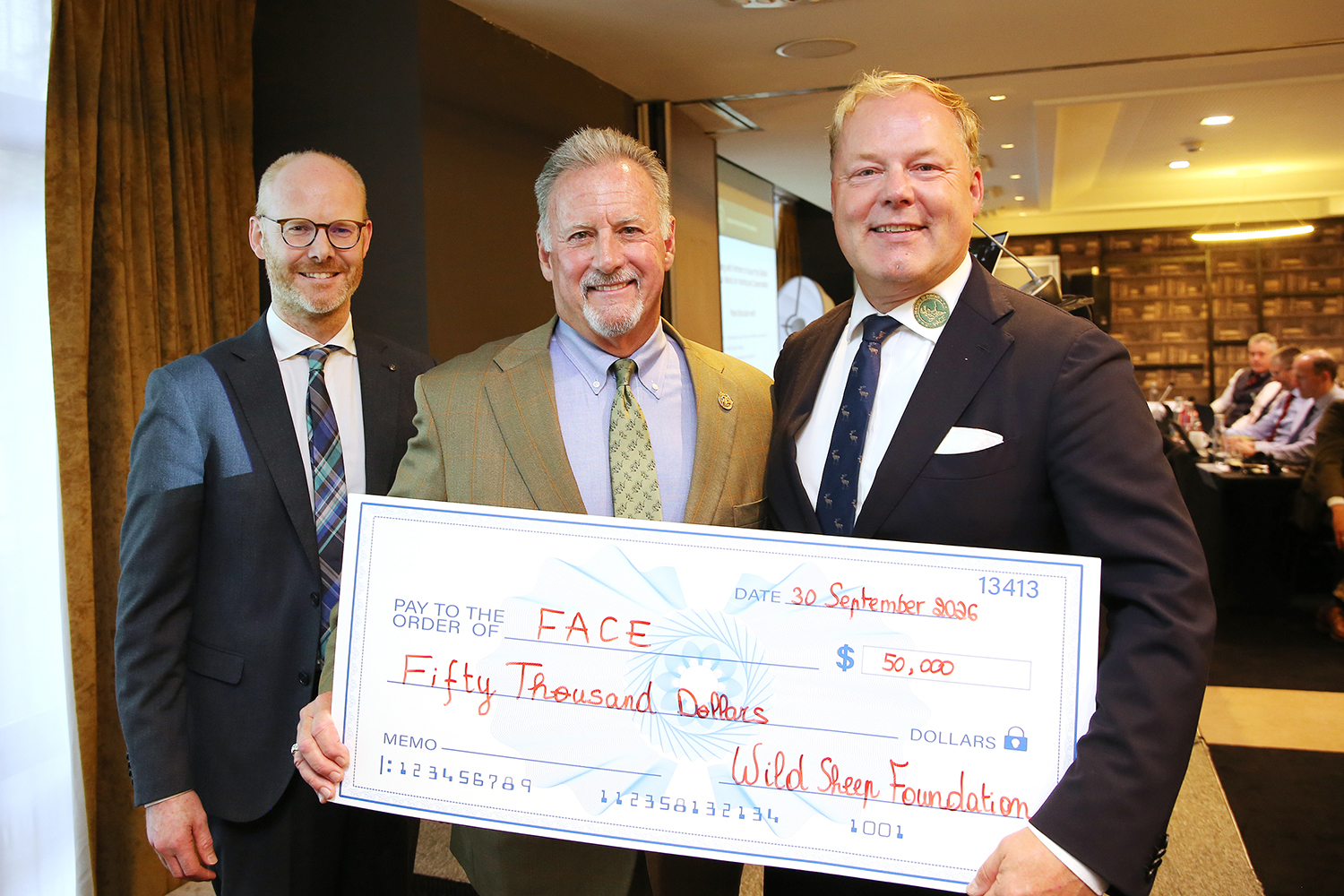 Gray Thornton with donation check at FACE conference