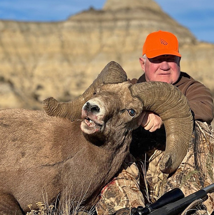 Hunter with the ram he harvested with the 2025 North Dakota permit tag
