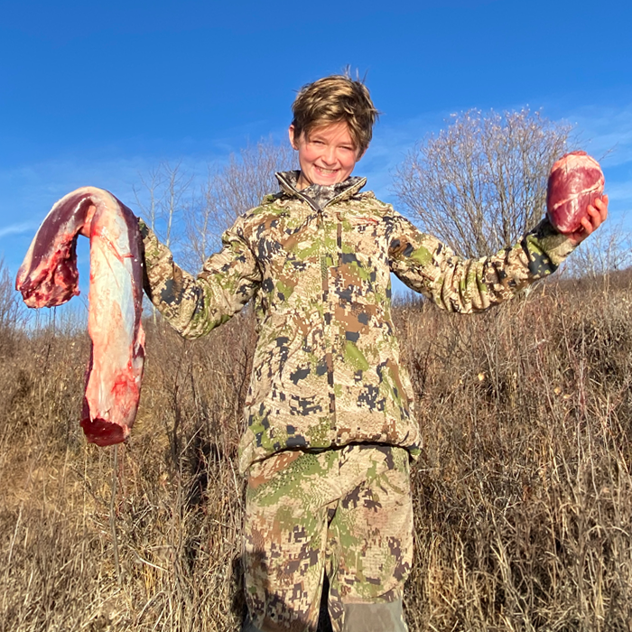 Young kid with meat from recent harvest