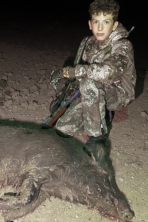 Youth hunter with wild hog that he harvested