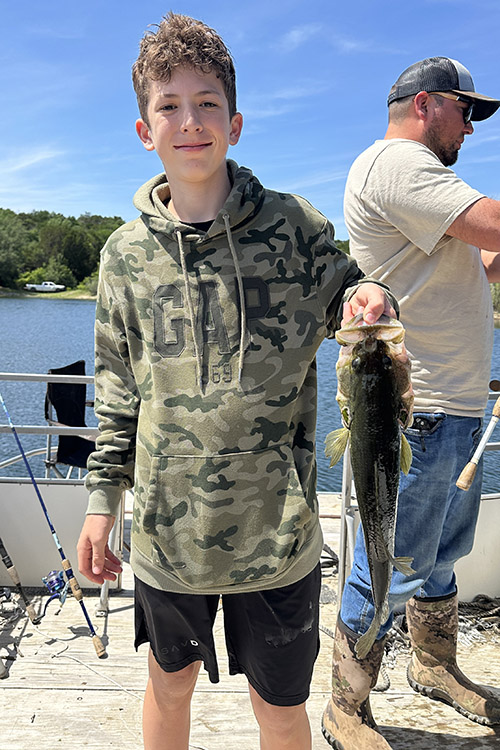 Young man with a fish he caught