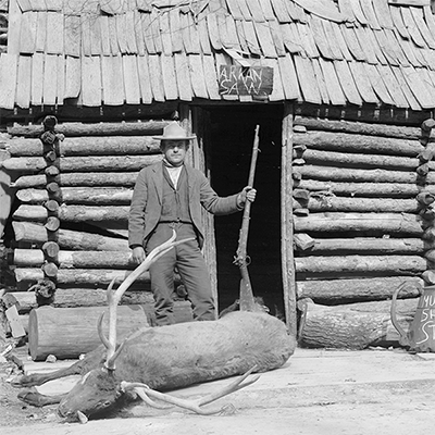 Arkansas cabin with a man and and elk