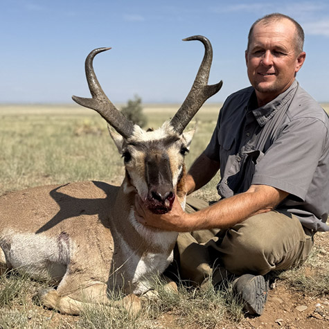 Hunter with a New Mexico pronghorn looking left Hunter with a New Mexico pronghorn looking left