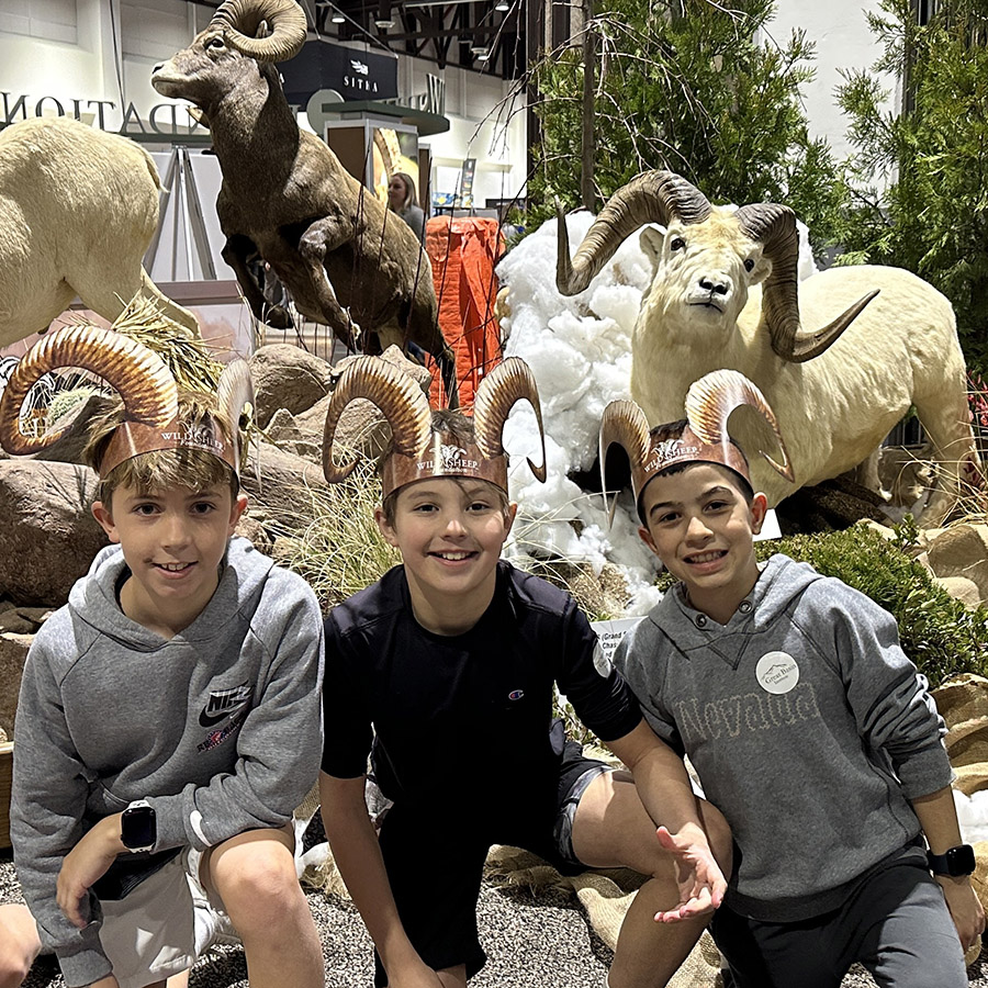 Youth attending the Sheep Show Expo in front a taxidermy display